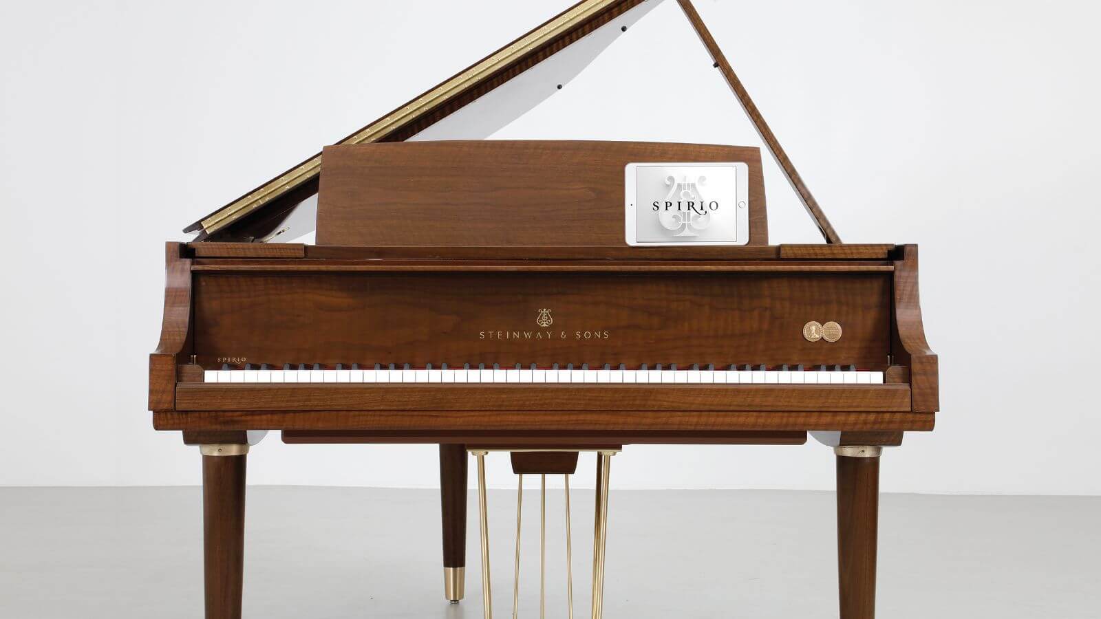 Front shot of brown Teague Piano Sketch 111 with white ipad on the piano